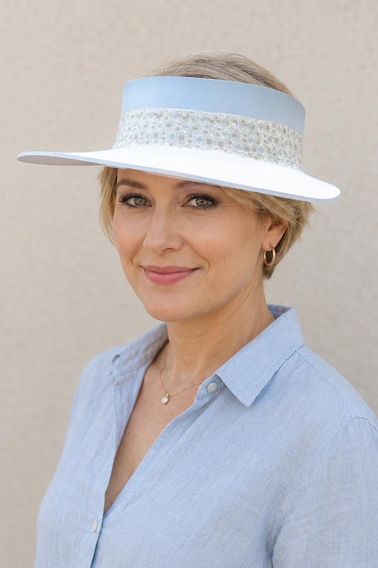 Woman wearing a light blue hat and shirt against a beige background