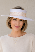 Woman wearing a wide-brimmed hat with a neutral background