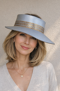 Woman wearing a light blue visor hat with a textured band against a neutral background