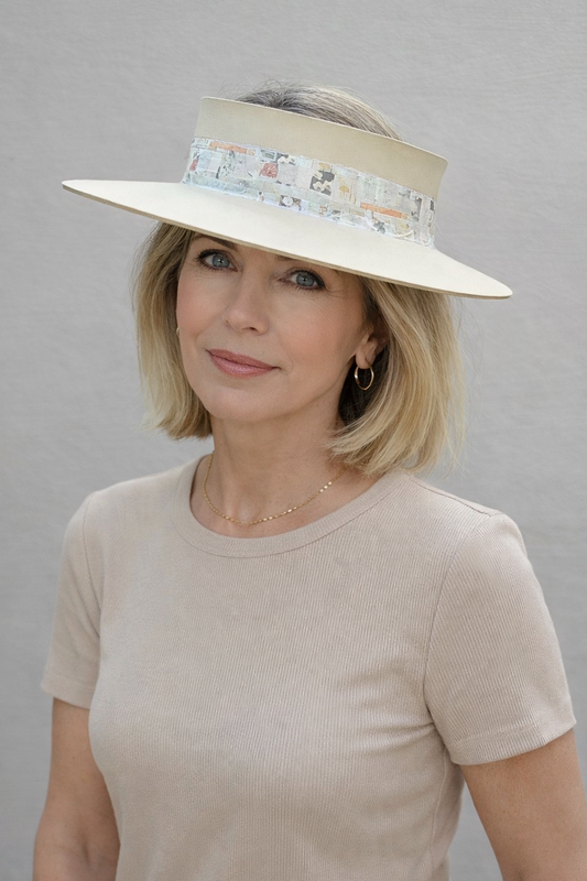 Woman wearing a beige hat with a floral band against a gray background