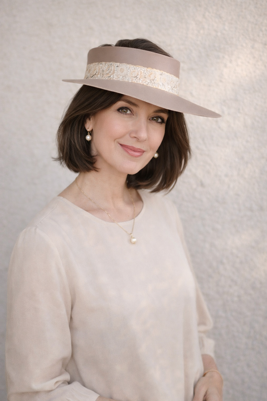 Woman wearing a beige hat with a textured background
