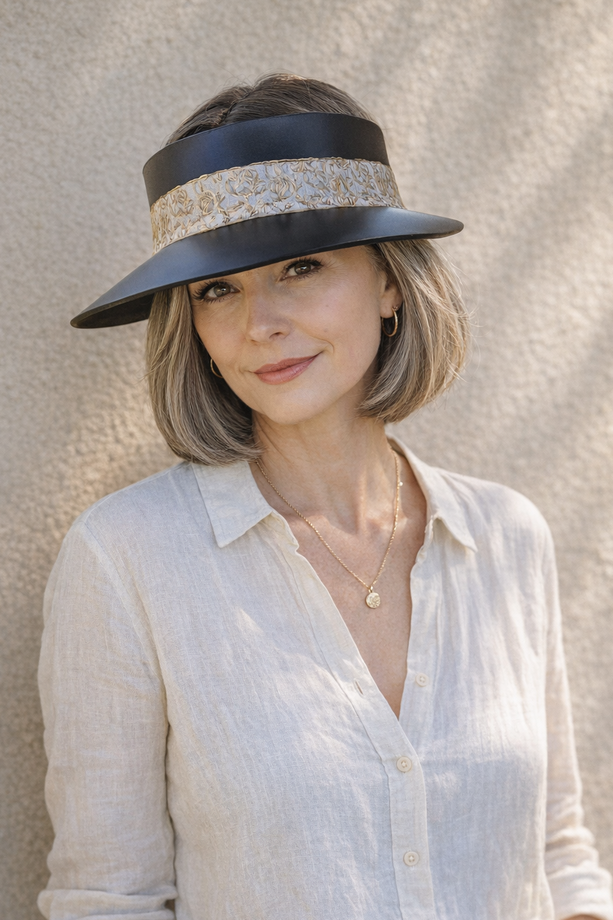 Woman wearing a wide-brimmed hat with a neutral background