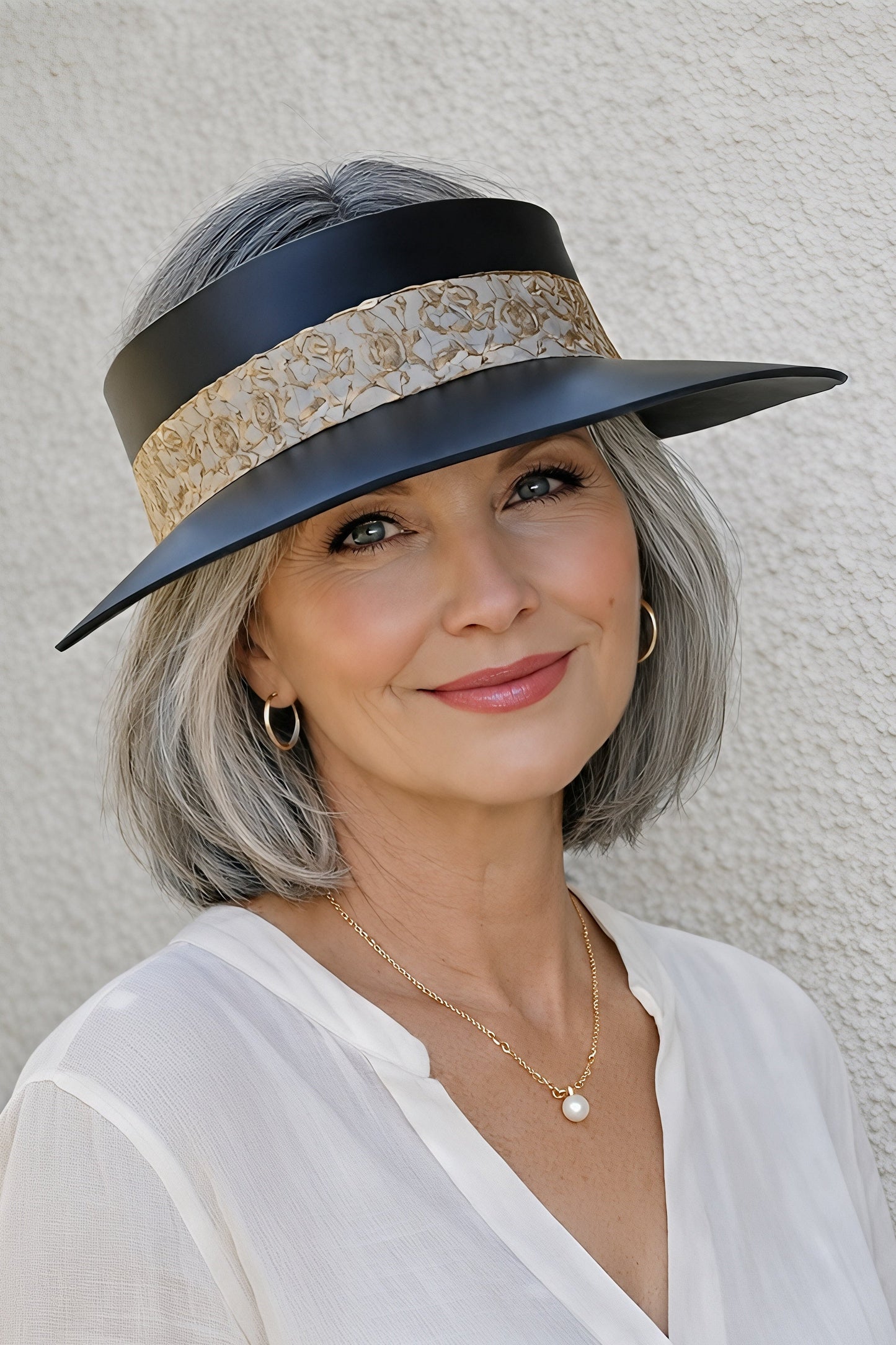 Woman wearing a stylish hat against a plain background