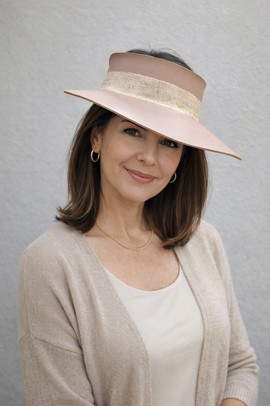 Woman wearing a wide-brimmed hat against a gray background