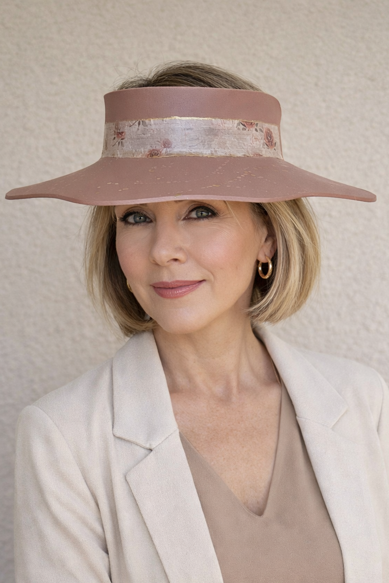 Woman wearing a wide-brimmed hat with a neutral background