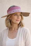 Woman wearing a visor with a floral pattern on a plain background