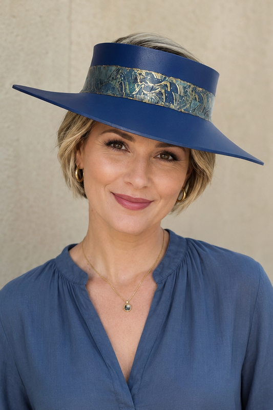 Woman wearing a blue hat and shirt against a beige background