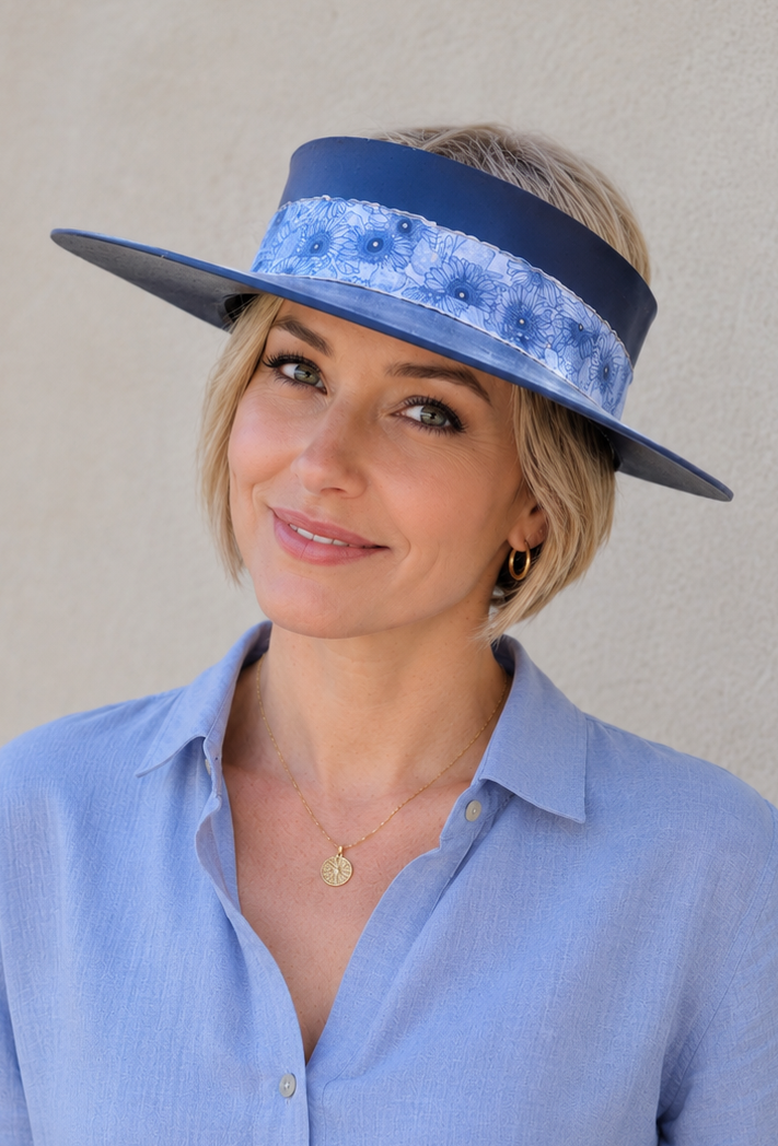 Woman wearing a blue hat and light blue shirt against a beige background