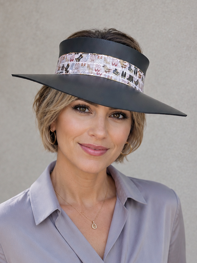 Woman wearing a wide-brimmed hat with a decorative band against a plain background