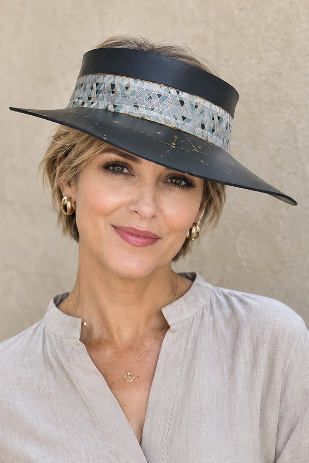 Woman wearing a stylish visor against a plain background