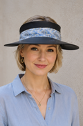 Woman wearing a blue visor hat and light blue shirt against a plain background