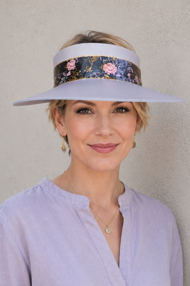 Woman wearing a floral visor against a plain background