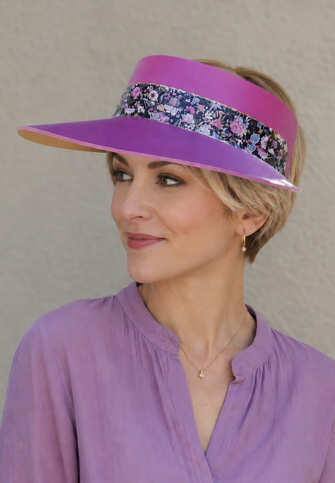 Woman wearing a purple visor and matching blouse against a neutral background