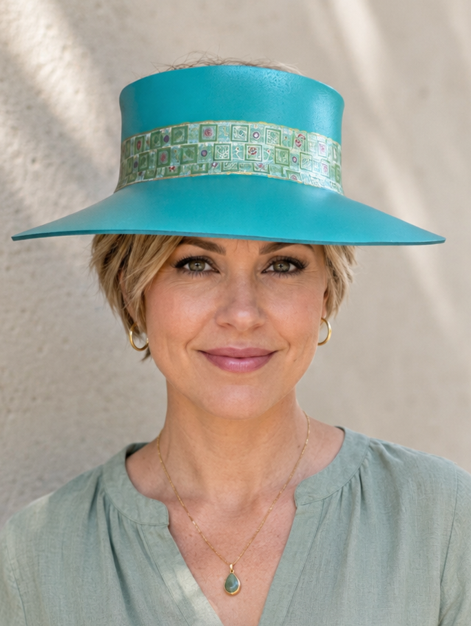 Woman wearing a turquoise hat against a neutral background