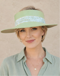 Woman wearing a light green visor and matching shirt against a beige background