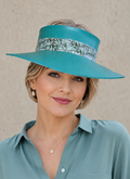 Woman wearing a teal visor and matching shirt against a beige background