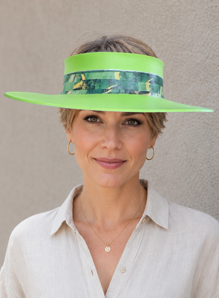 Woman wearing a bright green visor against a plain background