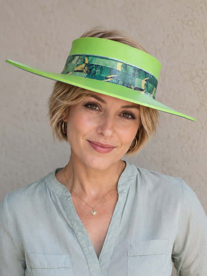 Woman wearing a bright green visor against a plain background