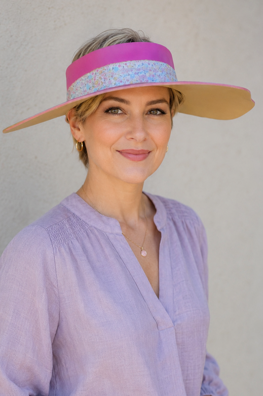Woman wearing a colorful visor against a plain background