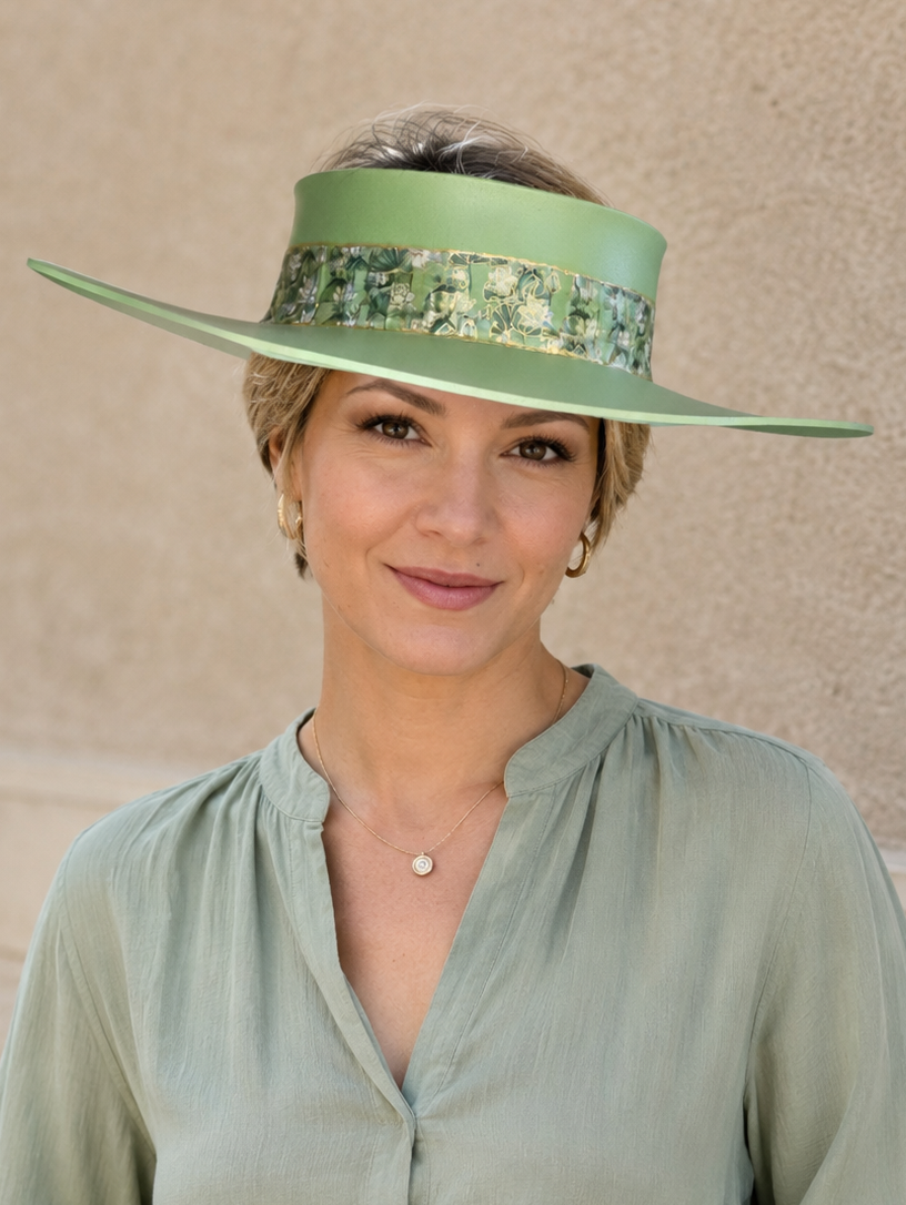 Woman wearing a green hat and matching outfit against a beige background