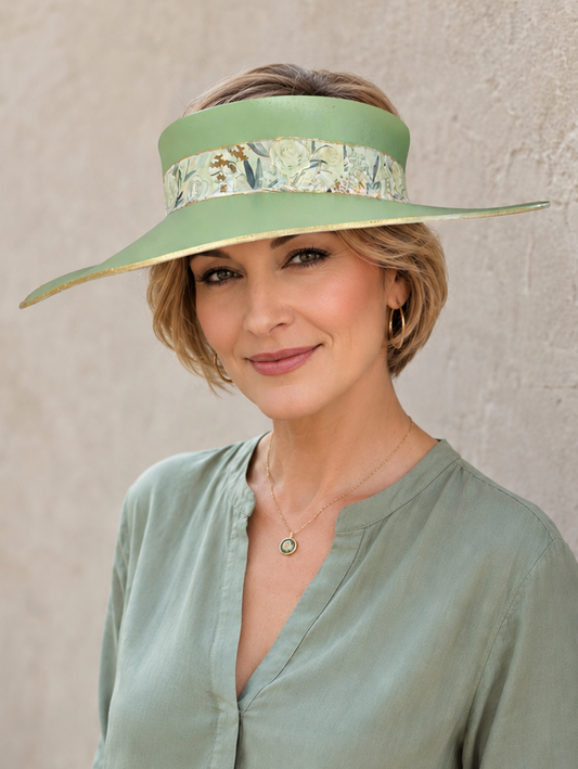 Woman wearing a green visor and matching blouse against a neutral background