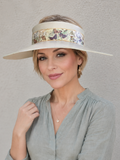 Woman wearing a floral visor with a plain background