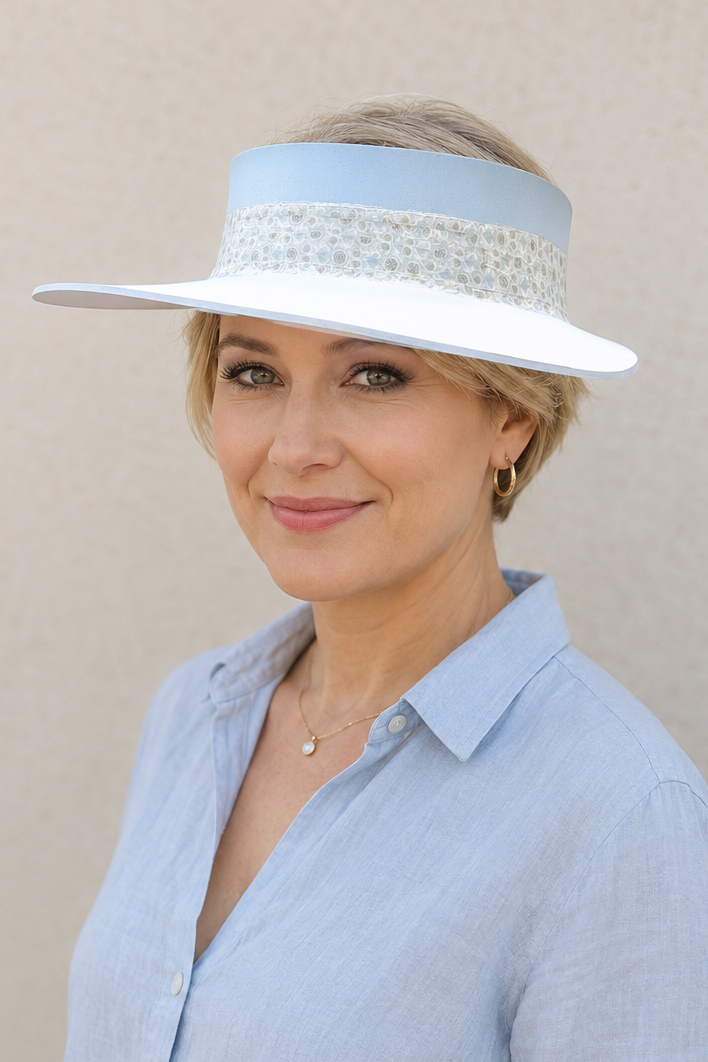 Woman wearing a light blue hat and shirt against a beige background