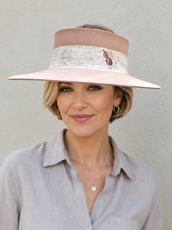 Woman wearing a wide-brimmed hat with a neutral background