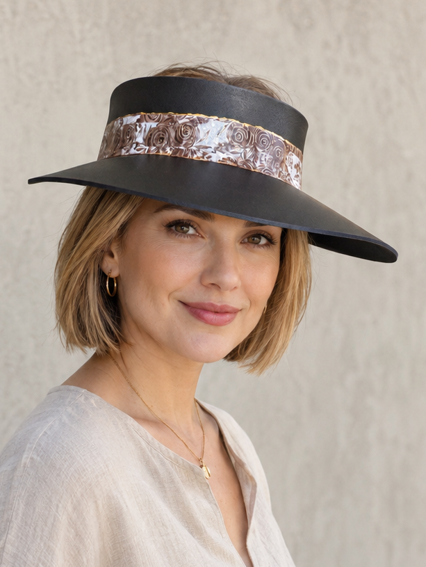 Woman wearing a wide-brimmed hat with a sequin band against a plain background