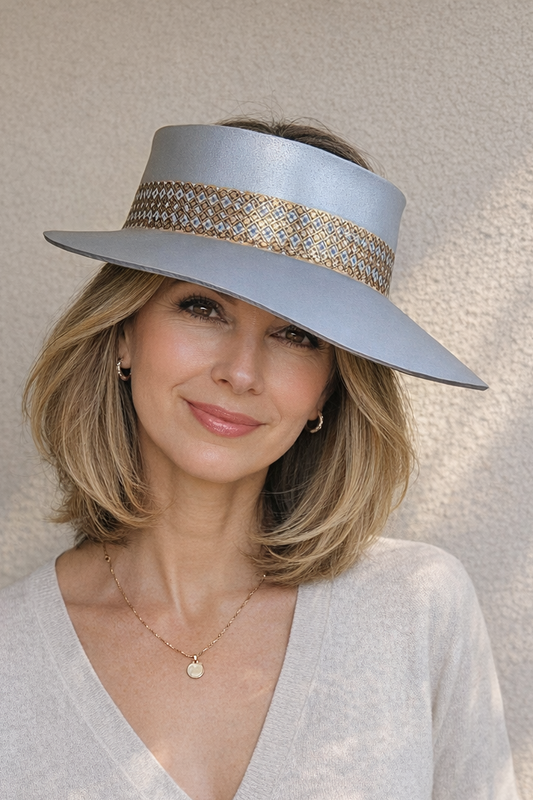 Woman wearing a light blue visor hat with a textured band against a neutral background