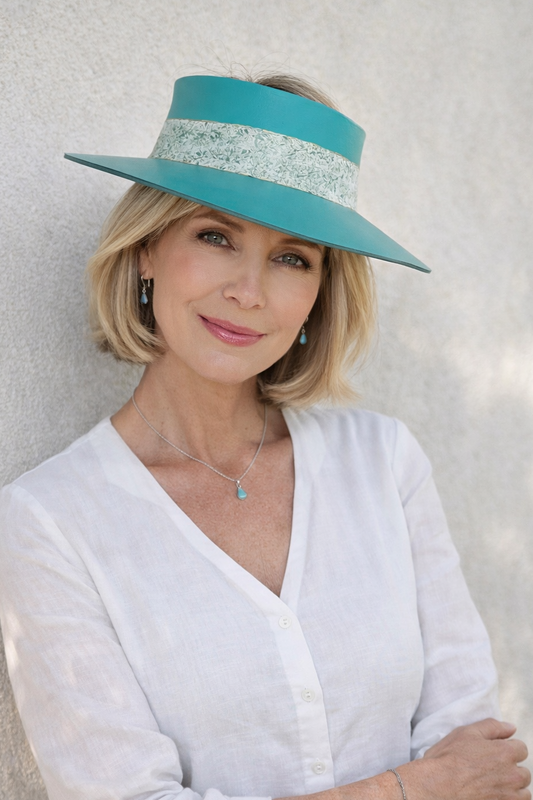Woman wearing a turquoise hat with a white background