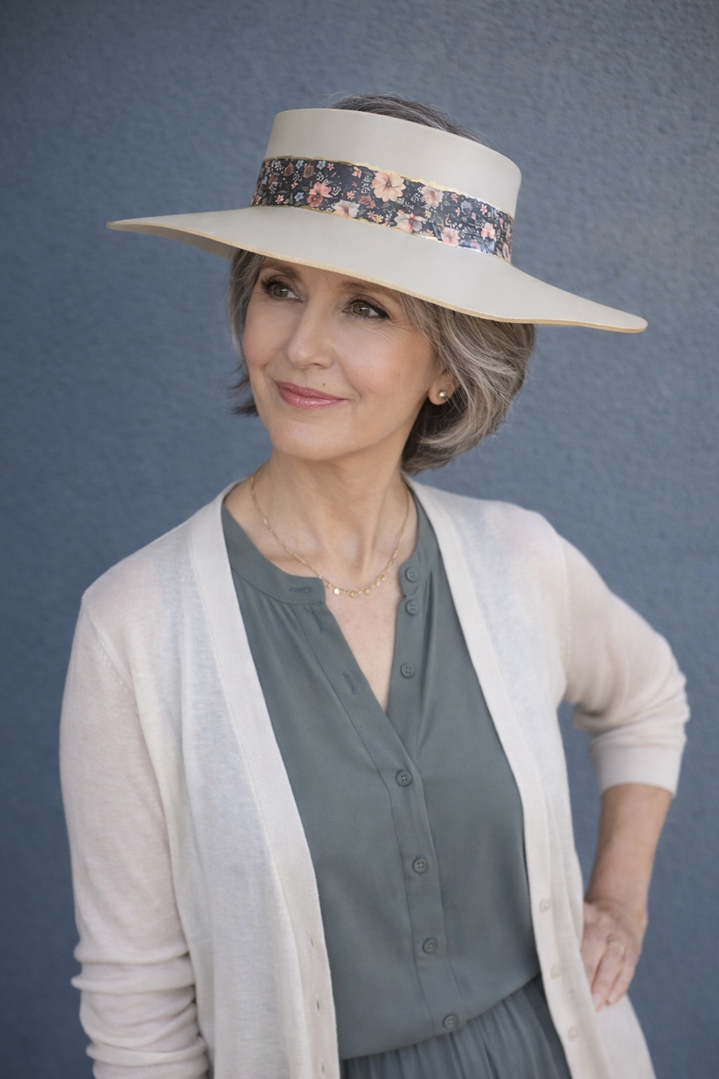 Woman wearing a wide-brimmed hat with a floral band against a blue background