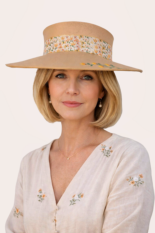 Woman wearing a beige sun hat with floral band on a white background
