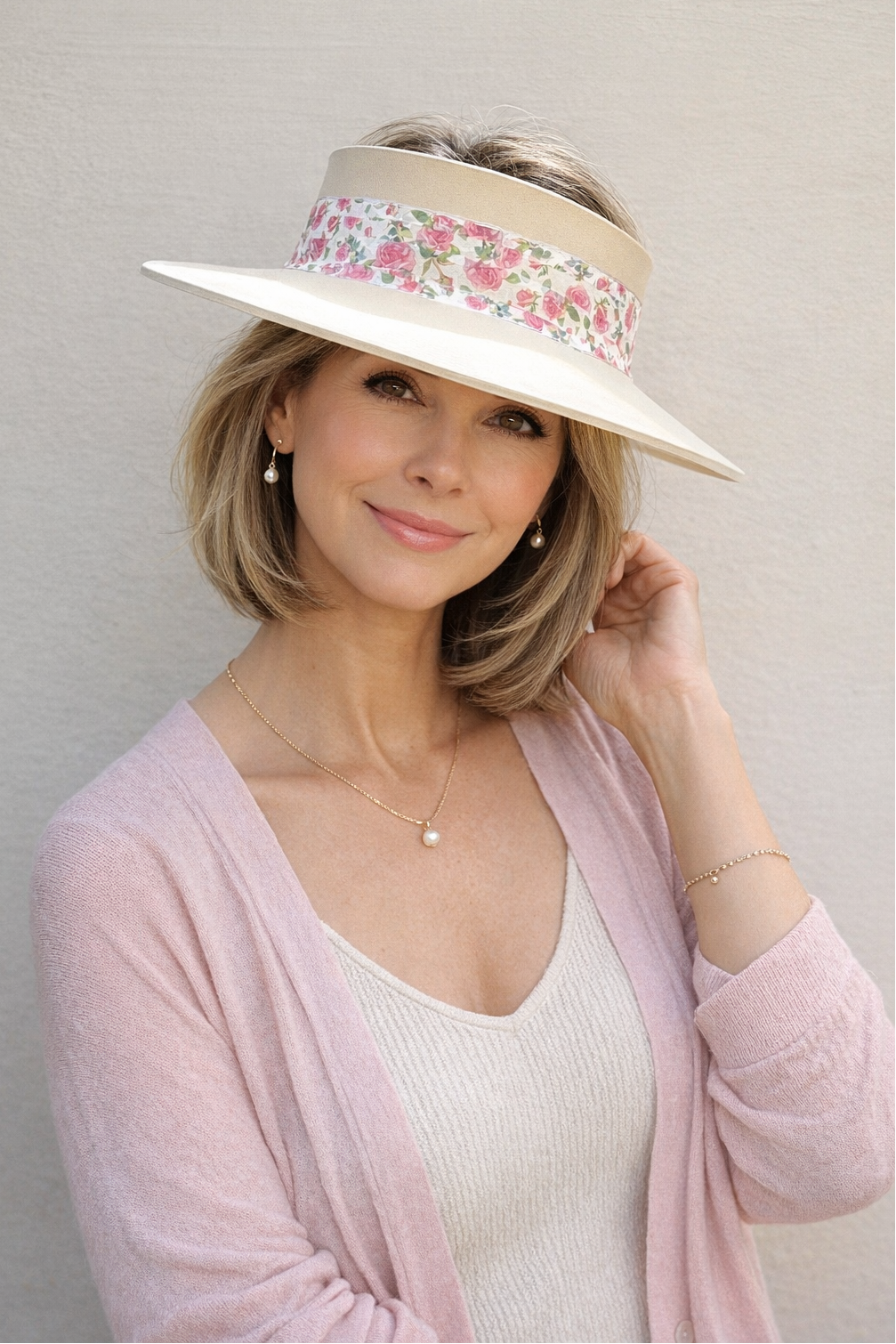 Woman wearing a floral visor with a plain background
