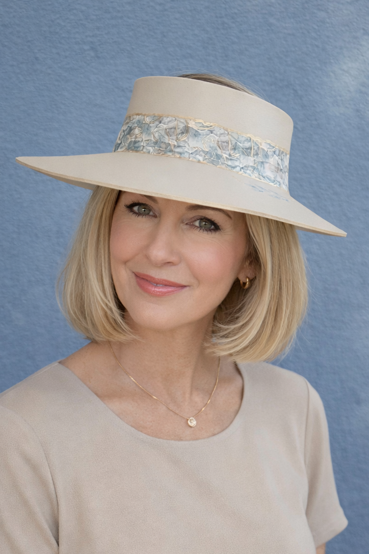 Woman wearing a beige hat with a blue background
