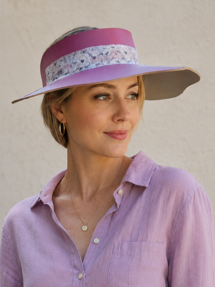Woman wearing a light purple shirt and a matching visor against a plain background